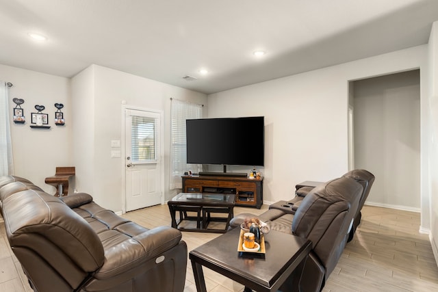 living area featuring recessed lighting, visible vents, baseboards, and light wood finished floors