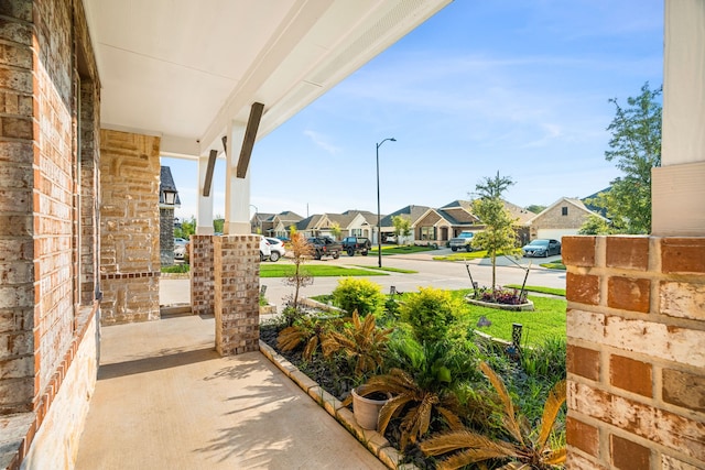 view of patio / terrace with covered porch and a residential view