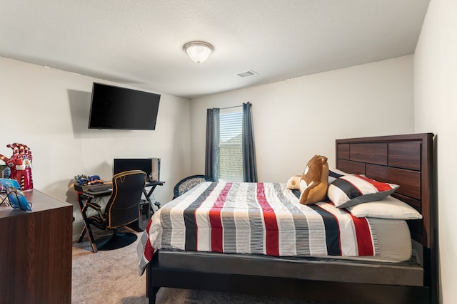 carpeted bedroom with visible vents and a textured ceiling