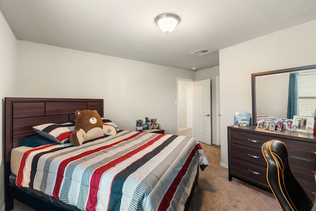 bedroom with visible vents and light carpet