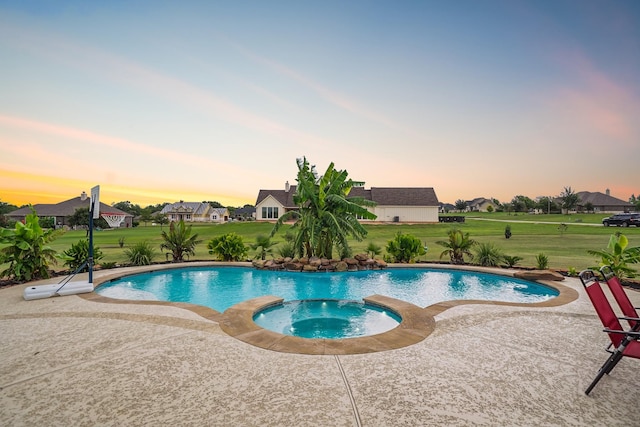 586 Ruby Dr, Bellville, TX 77418 - view of swimming pool featuring a residential view, a pool with connected hot tub, a lawn, and a patio