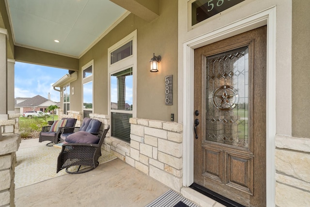 586 Ruby Dr, Bellville, TX 77418 - view of exterior entry with covered porch and stucco siding