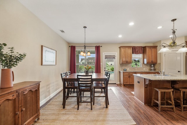 586 Ruby Dr, Bellville, TX 77418 - dining area featuring recessed lighting, visible vents, an inviting chandelier, wood finished floors, and baseboards
