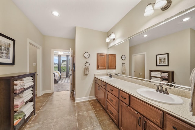 586 Ruby Dr, Bellville, TX 77418 - ensuite bathroom featuring tile patterned floors, connected bathroom, a sink, and double vanity