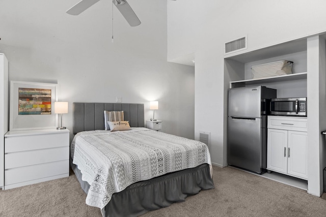 12600 Melville Dr Unit 316B, Montgomery, TX 77356 - bedroom with freestanding refrigerator, carpet flooring, a high ceiling, ceiling fan, and baseboards