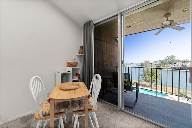 12600 Melville Dr Unit 316B, Montgomery, TX 77356 - dining space with floor to ceiling windows, a ceiling fan, carpet flooring, healthy amount of natural light, and a water view