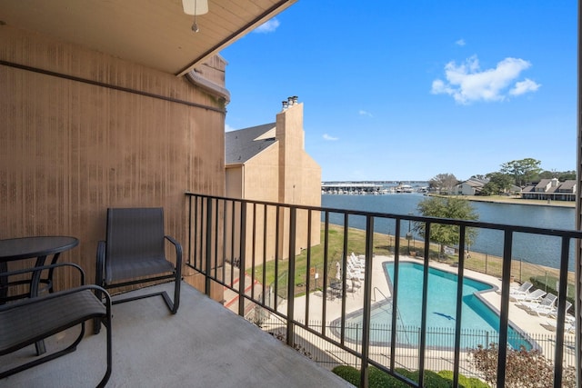 balcony with a water view and ceiling fan