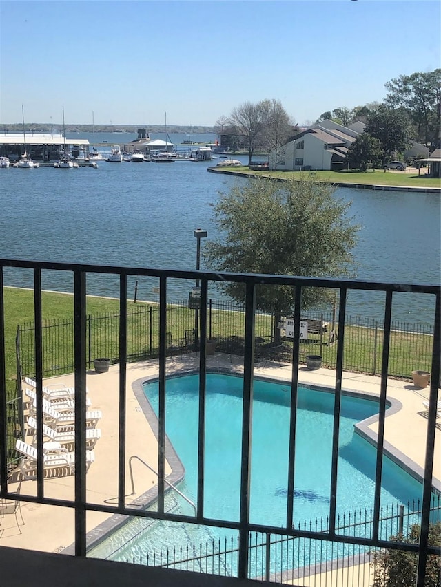 12600 Melville Dr Unit 316B, Montgomery, TX 77356 - view of swimming pool featuring a water view, fence, and a patio area