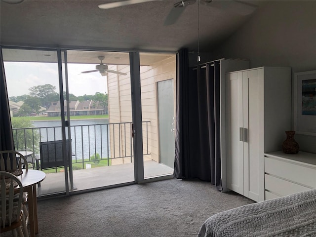 12600 Melville Dr Unit 316B, Montgomery, TX 77356 - bedroom with access to exterior, a water view, carpet flooring, floor to ceiling windows, and ceiling fan