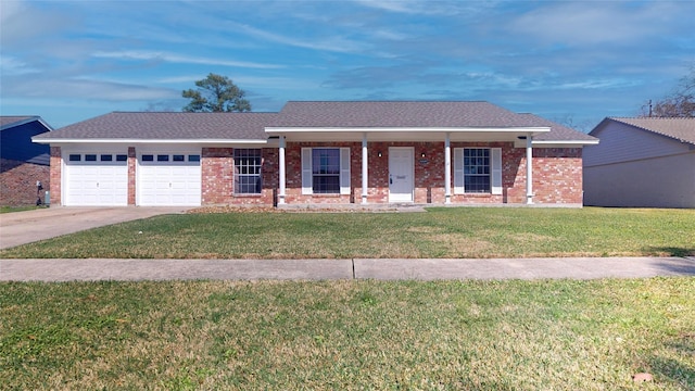 ranch-style home featuring a garage, covered porch, brick siding, driveway, and a front yard