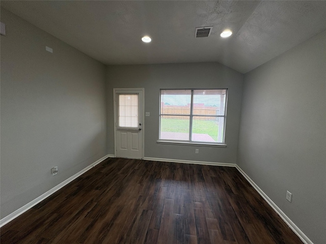 interior space with lofted ceiling, recessed lighting, visible vents, dark wood-type flooring, and baseboards