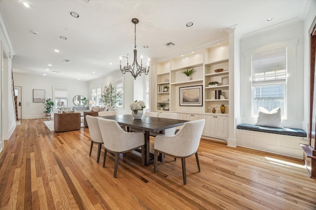 dining room with light wood-style floors, built in shelves, crown molding, and recessed lighting