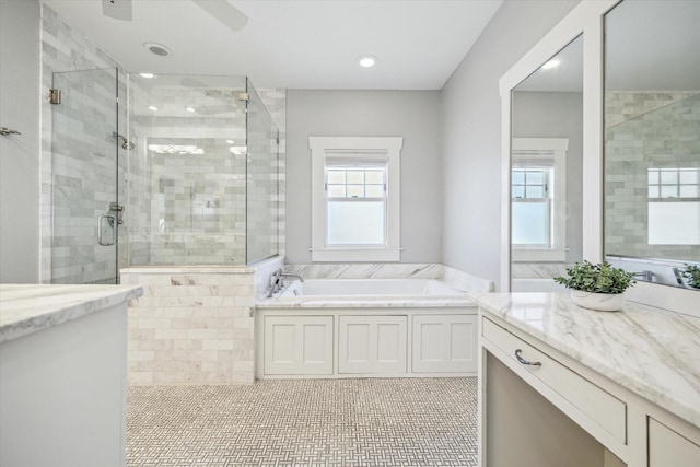 full bath with a garden tub, plenty of natural light, a shower stall, and vanity