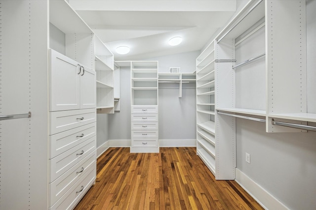 spacious closet with dark wood-style flooring and visible vents