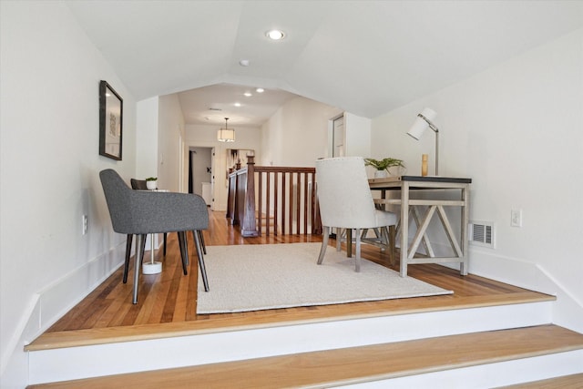 home office with recessed lighting, visible vents, vaulted ceiling, and wood finished floors