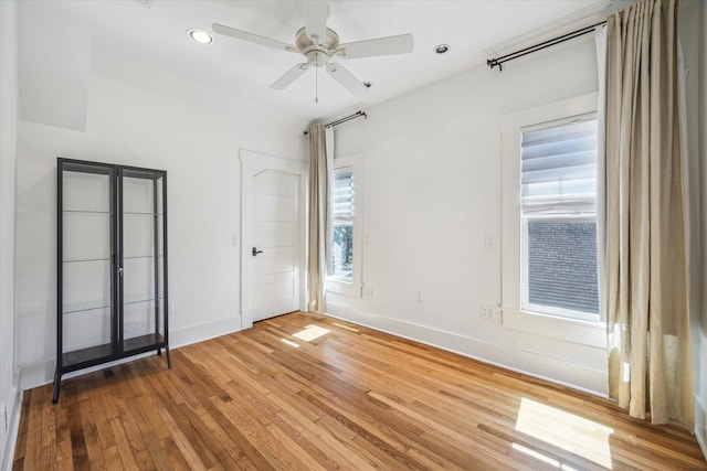 spare room featuring baseboards, ceiling fan, recessed lighting, and light wood-style floors