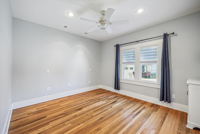 unfurnished room with light wood-type flooring, ceiling fan, baseboards, and recessed lighting