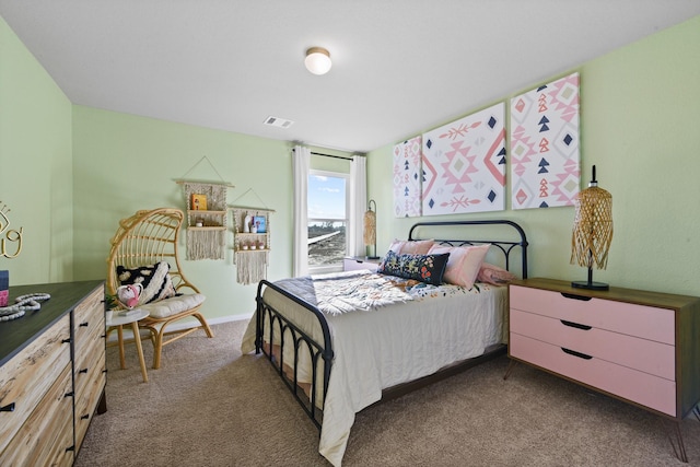 bedroom with dark colored carpet and visible vents