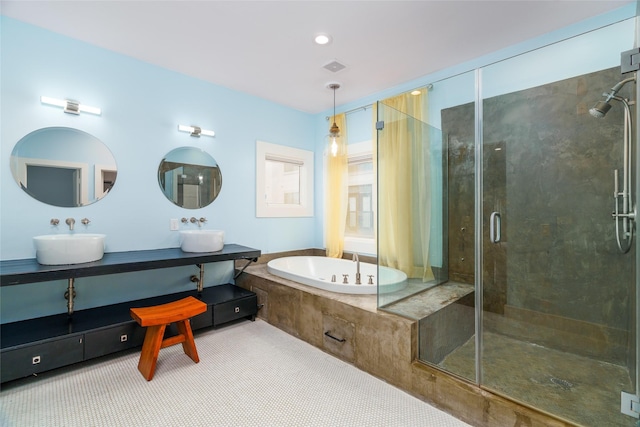 1016 Crocker St, Houston, TX 77019 - full bathroom featuring a sink, visible vents, a shower stall, a bath, and double vanity