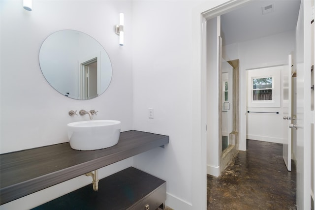 1016 Crocker St, Houston, TX 77019 - bathroom featuring concrete flooring, a sink, visible vents, and baseboards