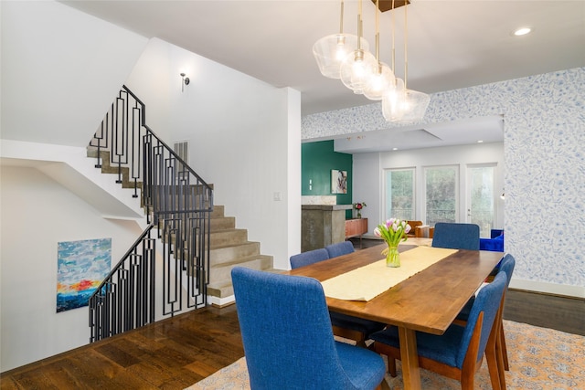 1016 Crocker St, Houston, TX 77019 - dining area featuring wallpapered walls, stairs, baseboards, and dark wood finished floors