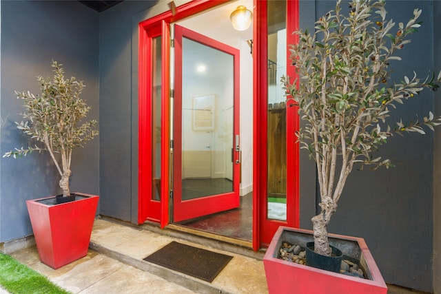 entrance to property featuring stucco siding