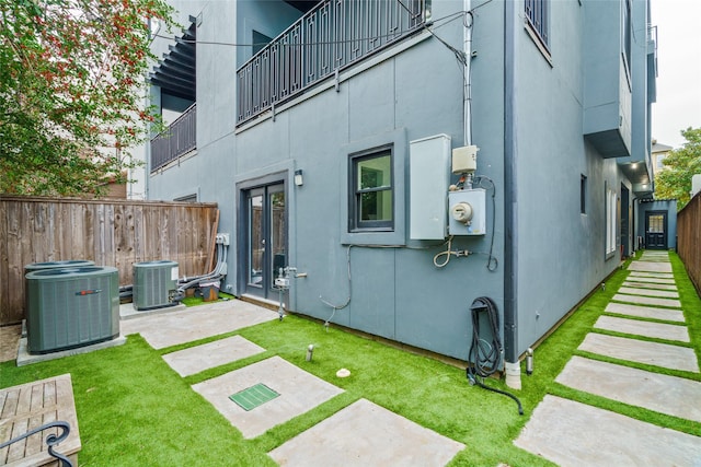 1016 Crocker St, Houston, TX 77019 - back of house with cooling unit, fence, a patio, and stucco siding