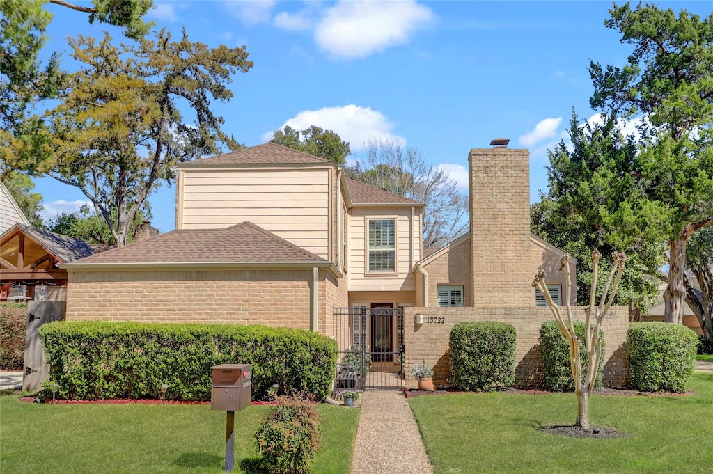 15722 Steamboat Ln, Houston, TX 77079 - traditional-style house with a front lawn, a chimney, a gate, and fence