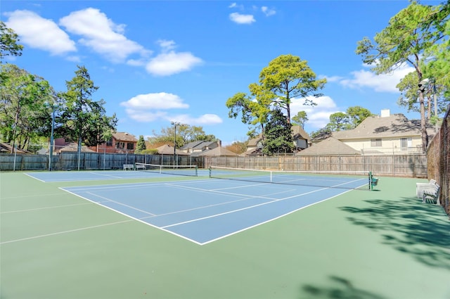 view of sport court featuring fence