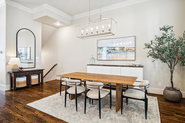 dining area featuring baseboards, ornamental molding, and dark wood-type flooring