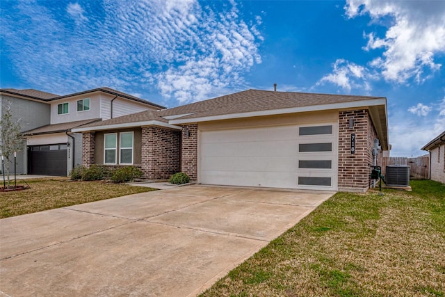 view of front of home with a garage, concrete driveway, central air condition unit, a front lawn, and brick siding