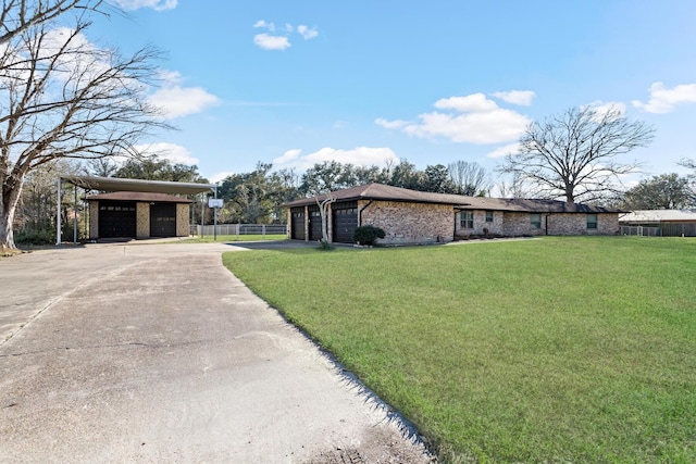 view of front facade with a garage, brick siding, a front yard, and fence