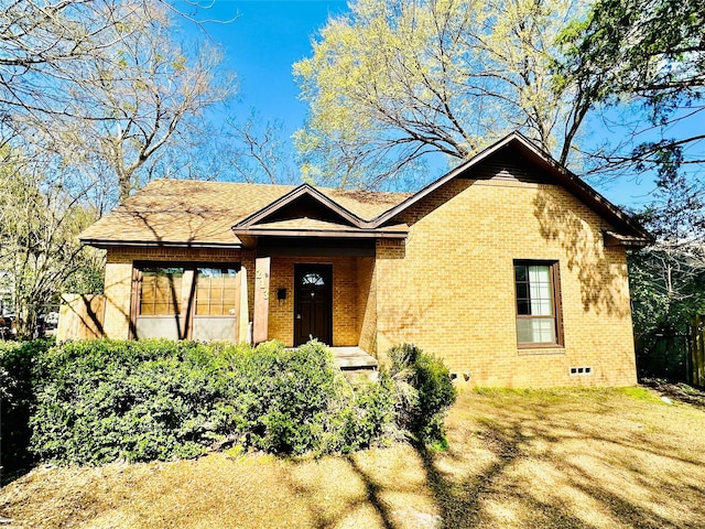 view of front facade with brick siding and crawl space