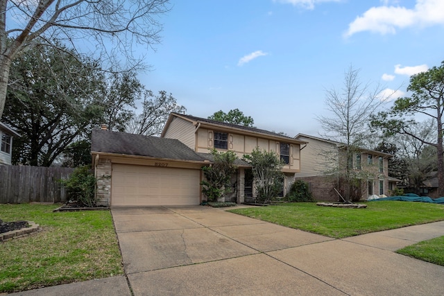 traditional-style home featuring fence, concrete driveway, a front yard, a garage, and stone siding