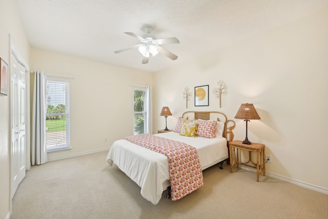 4105 Nueces Dr, Galveston, TX 77554 - bedroom with light carpet, ceiling fan, and baseboards