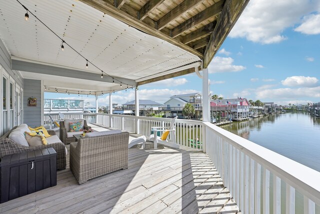 4105 Nueces Dr, Galveston, TX 77554 - wooden deck featuring a water view and an outdoor hangout area