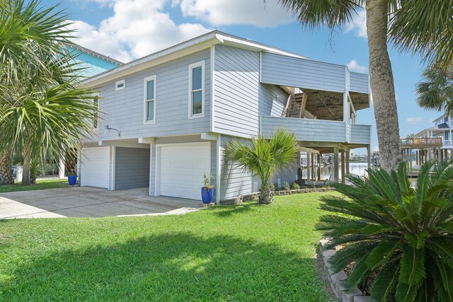 4105 Nueces Dr, Galveston, TX 77554 - view of front facade featuring an attached garage and a front yard