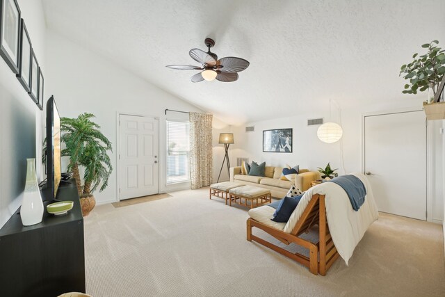 4105 Nueces Dr, Galveston, TX 77554 - living area with visible vents, a ceiling fan, light carpet, vaulted ceiling, and a textured ceiling