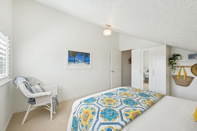 4105 Nueces Dr, Galveston, TX 77554 - bedroom with baseboards, vaulted ceiling, a textured ceiling, and light colored carpet