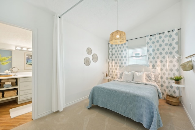 4105 Nueces Dr, Galveston, TX 77554 - bedroom featuring light colored carpet, vaulted ceiling, and baseboards