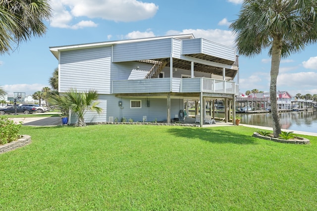 4105 Nueces Dr, Galveston, TX 77554 - rear view of property with a water view, a lawn, and a balcony