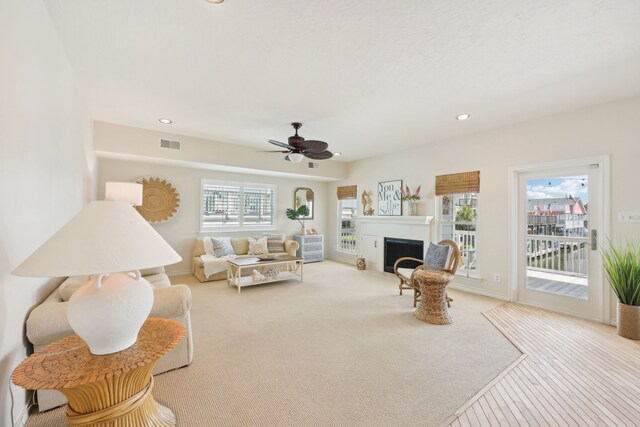 4105 Nueces Dr, Galveston, TX 77554 - living area featuring light carpet, plenty of natural light, a fireplace, and visible vents