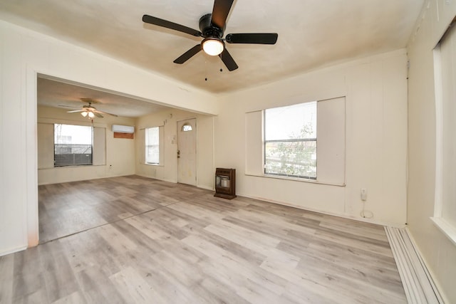 unfurnished living room with light wood-type flooring and a wall mounted AC