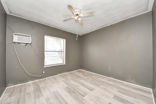 spare room with light wood-style floors, an AC wall unit, crown molding, and ceiling fan