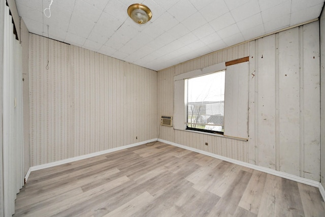 empty room featuring light wood-type flooring and baseboards