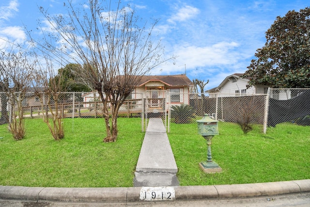 view of front of property with fence and a front lawn