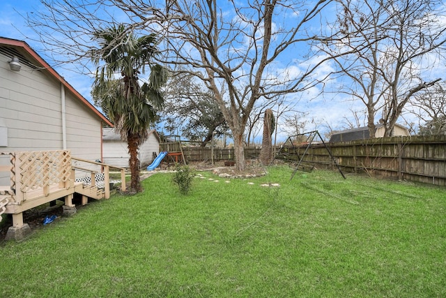 view of yard with a fenced backyard and a playground