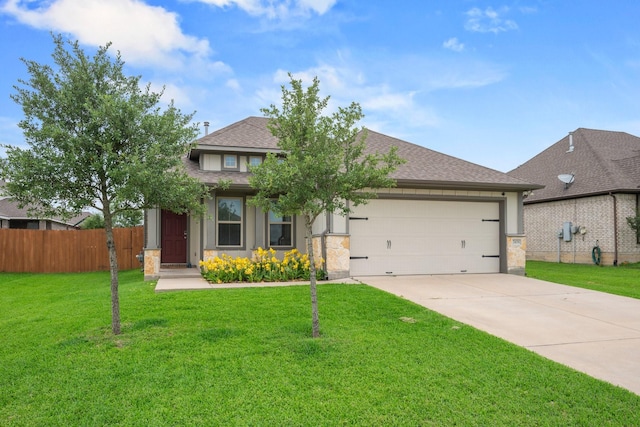 view of front of house featuring a front lawn, fence, a shingled roof, an attached garage, and driveway
