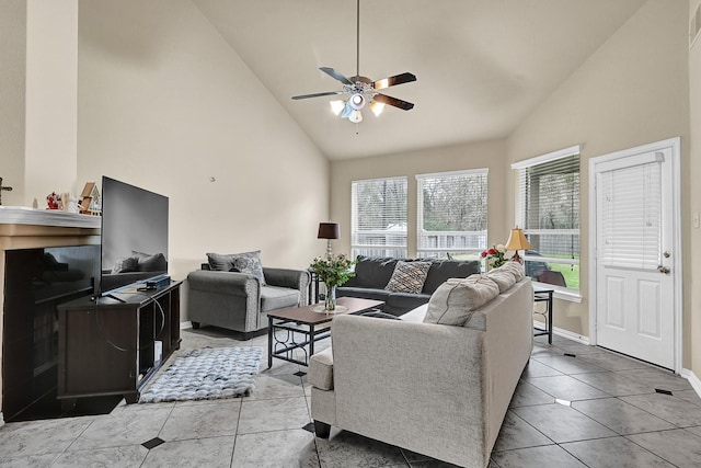 living area featuring high vaulted ceiling, light tile patterned flooring, ceiling fan, and baseboards