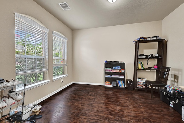 miscellaneous room featuring baseboards, a textured ceiling, visible vents, and dark wood-type flooring